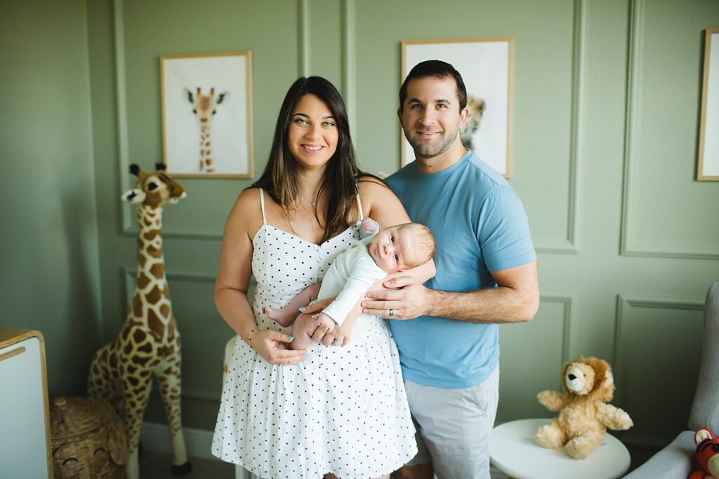 Orlando newborn photographer capturing baby in parents arms at home