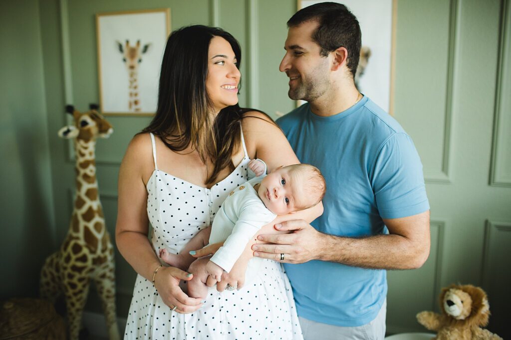 Orlando newborn photographer capturing baby in parents arms at home