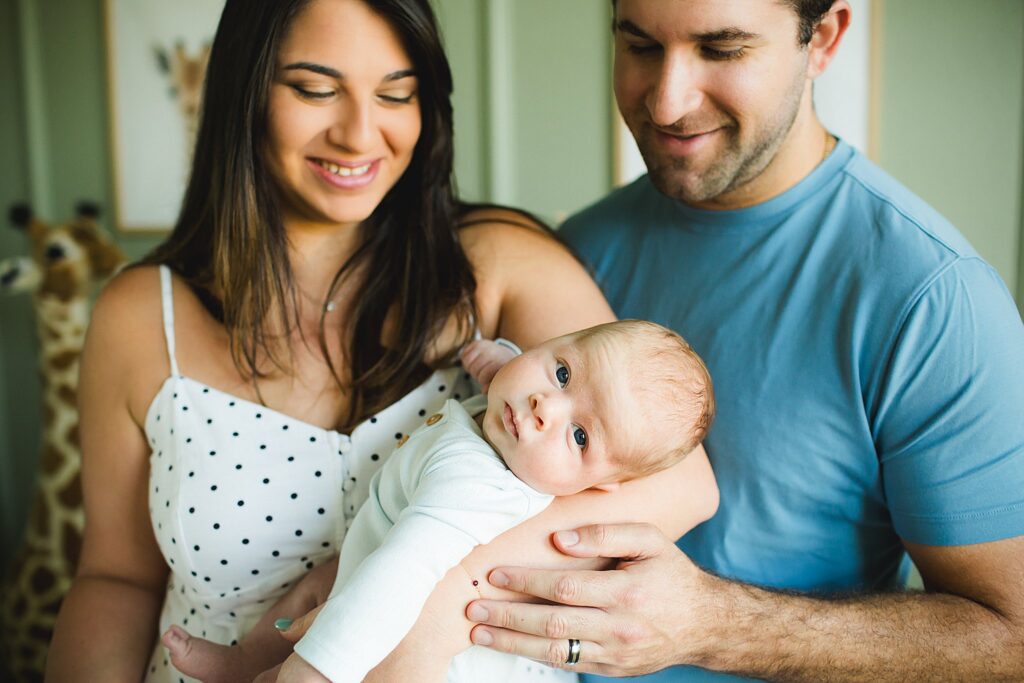 Orlando newborn photographer capturing baby in parents arms at home