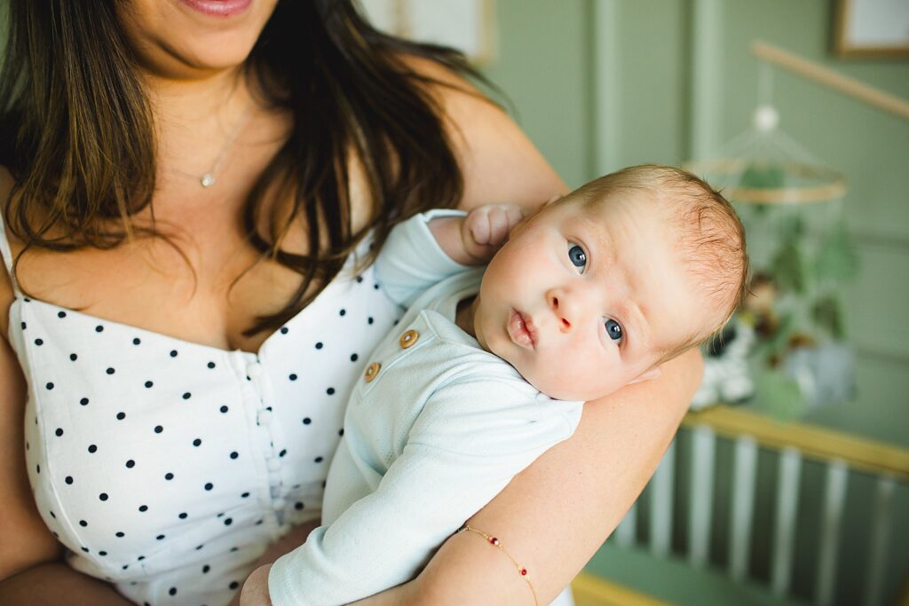 Orlando newborn photographer capturing baby in parents arms at home