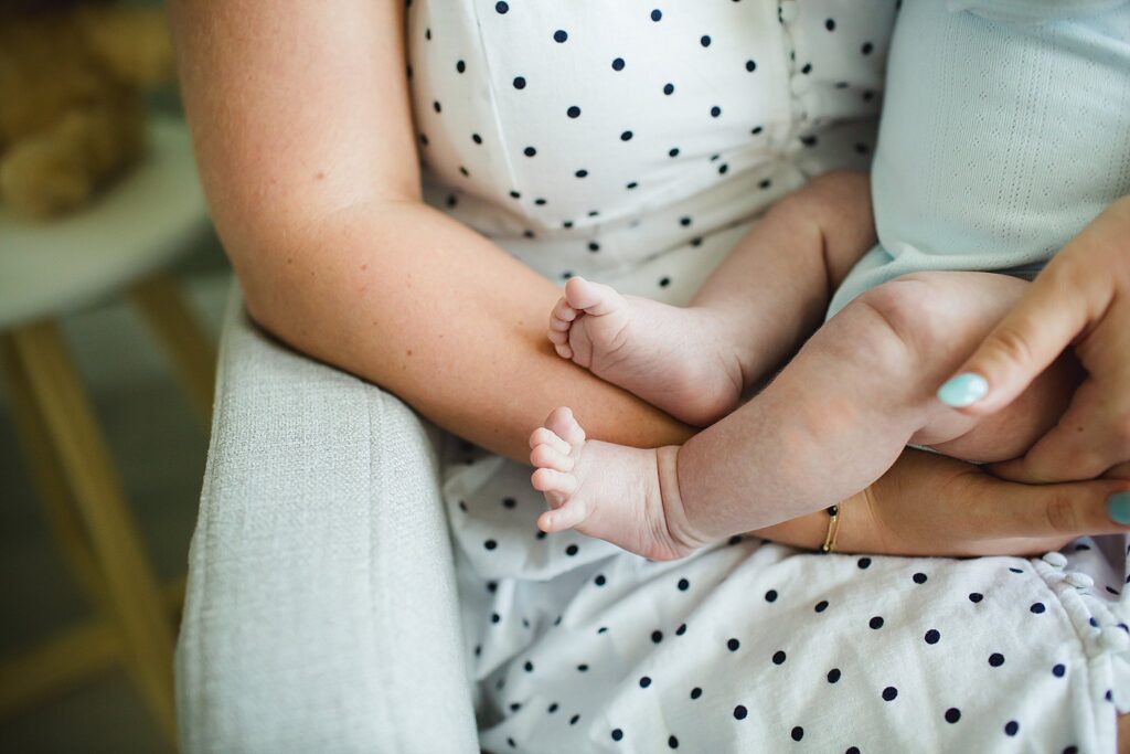 Orlando newborn photographer capturing baby in parents arms at home
