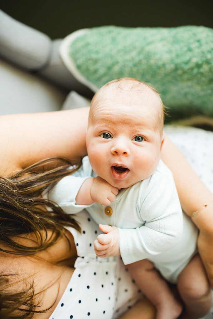 Orlando newborn photographer capturing baby in parents arms at home