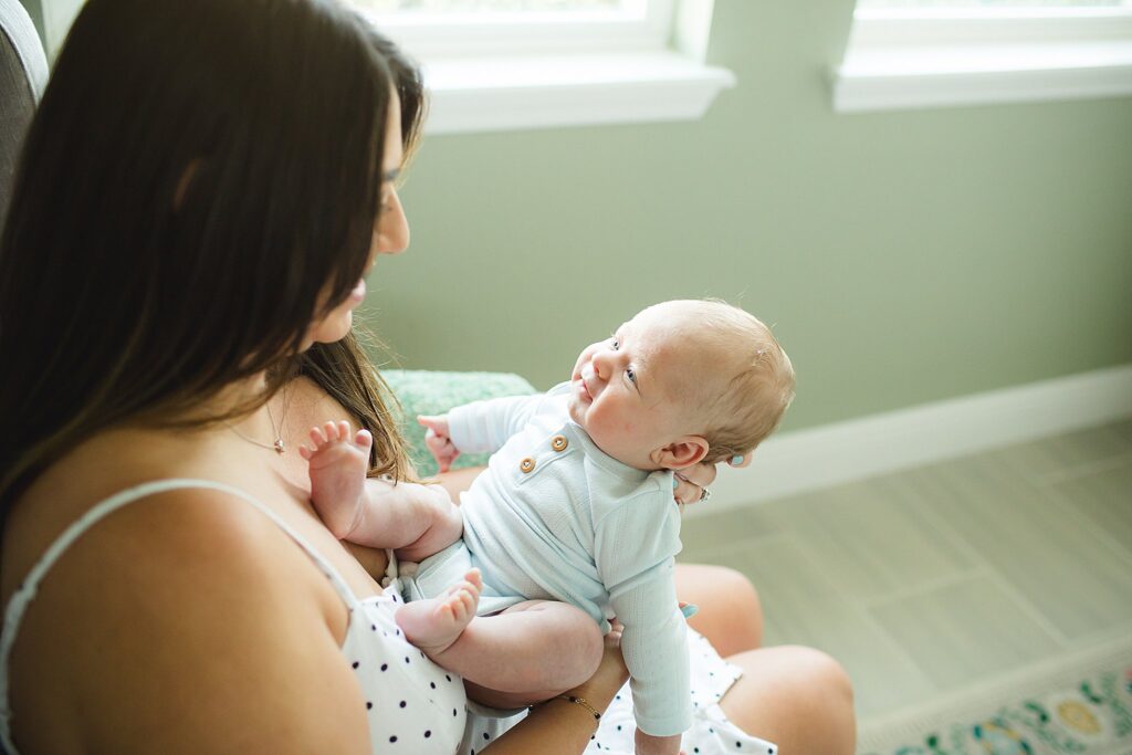 Orlando newborn photographer capturing baby in parents arms at home
