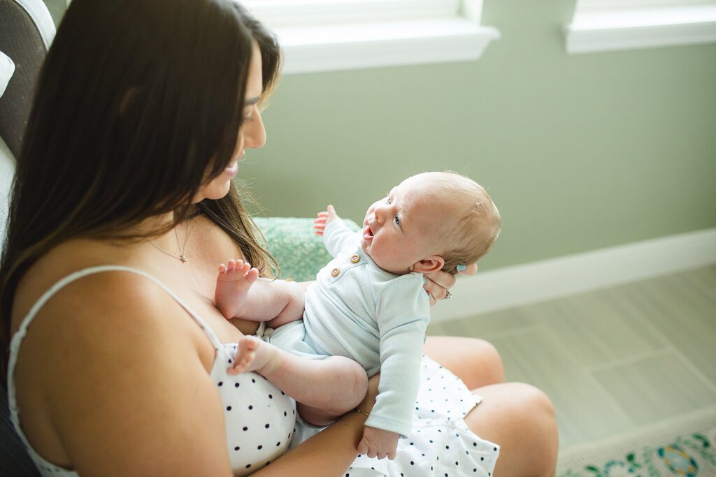 Orlando newborn photographer capturing baby in parents arms at home