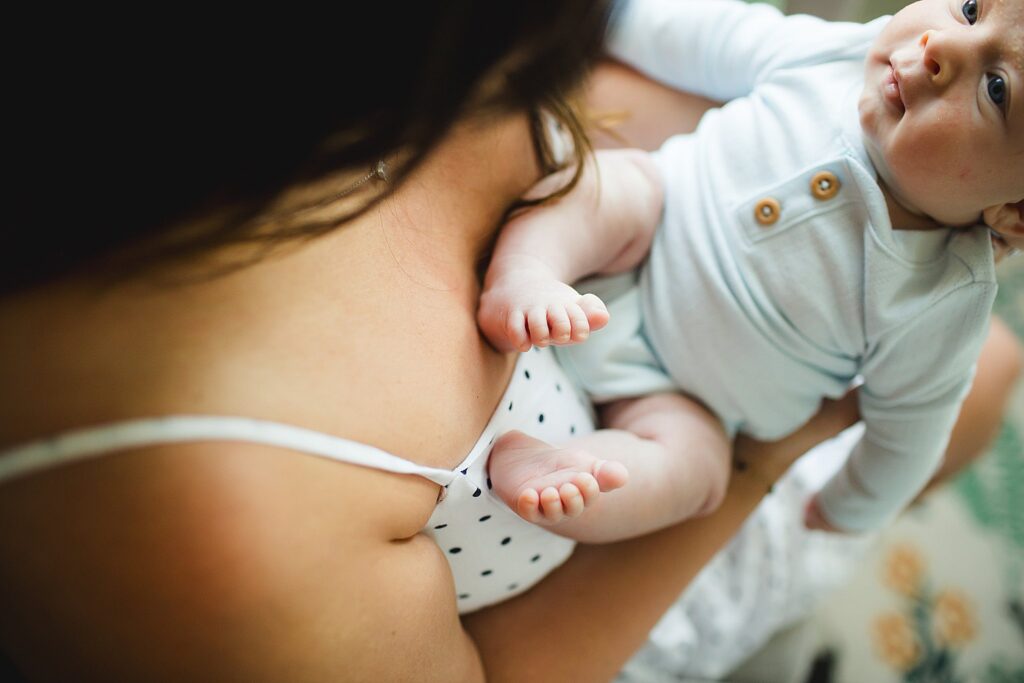 Orlando newborn photographer capturing baby in parents arms at home