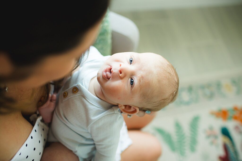 Orlando newborn photographer capturing baby in parents arms at home