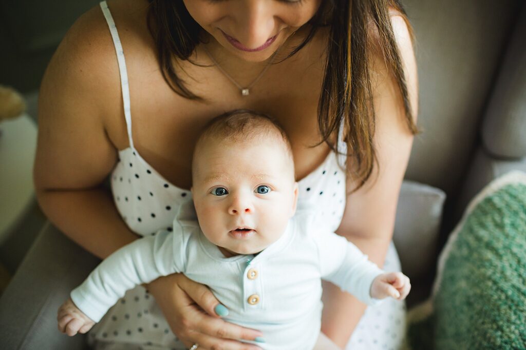 Orlando newborn photographer capturing baby in parents arms at home