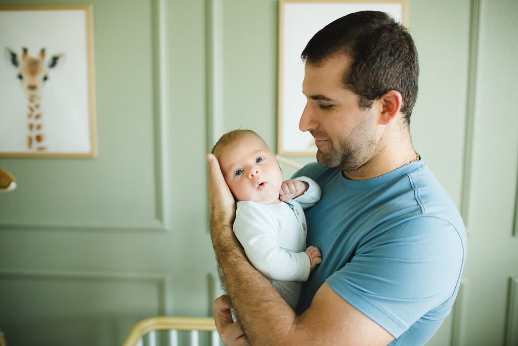 Orlando newborn photographer capturing baby in parents arms at home