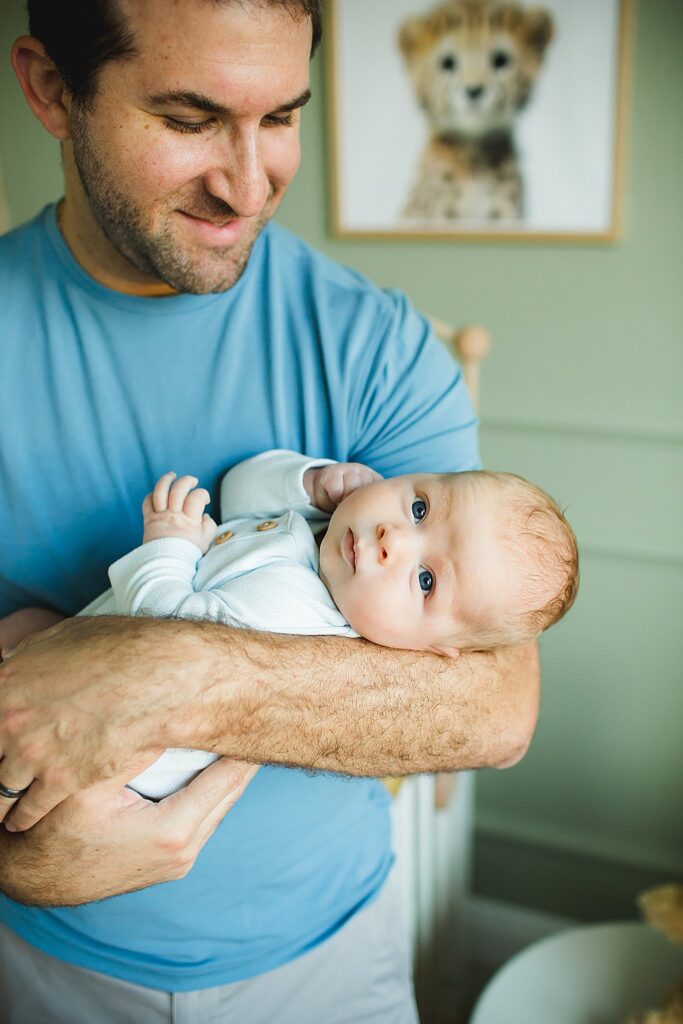 Orlando newborn photographer capturing baby in parents arms at home