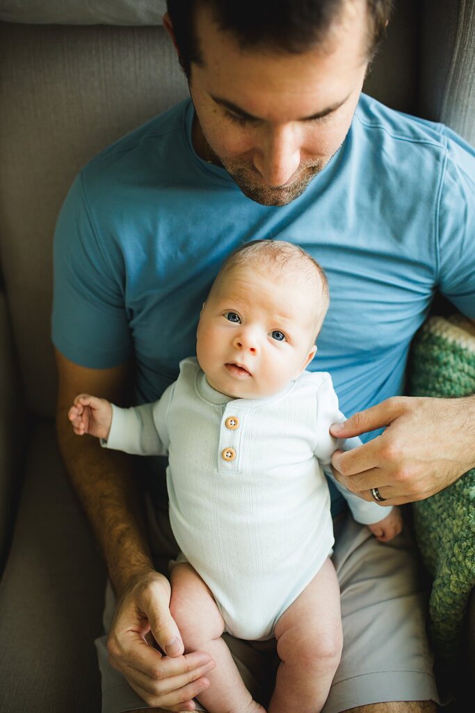 Orlando newborn photographer capturing baby in parents arms at home