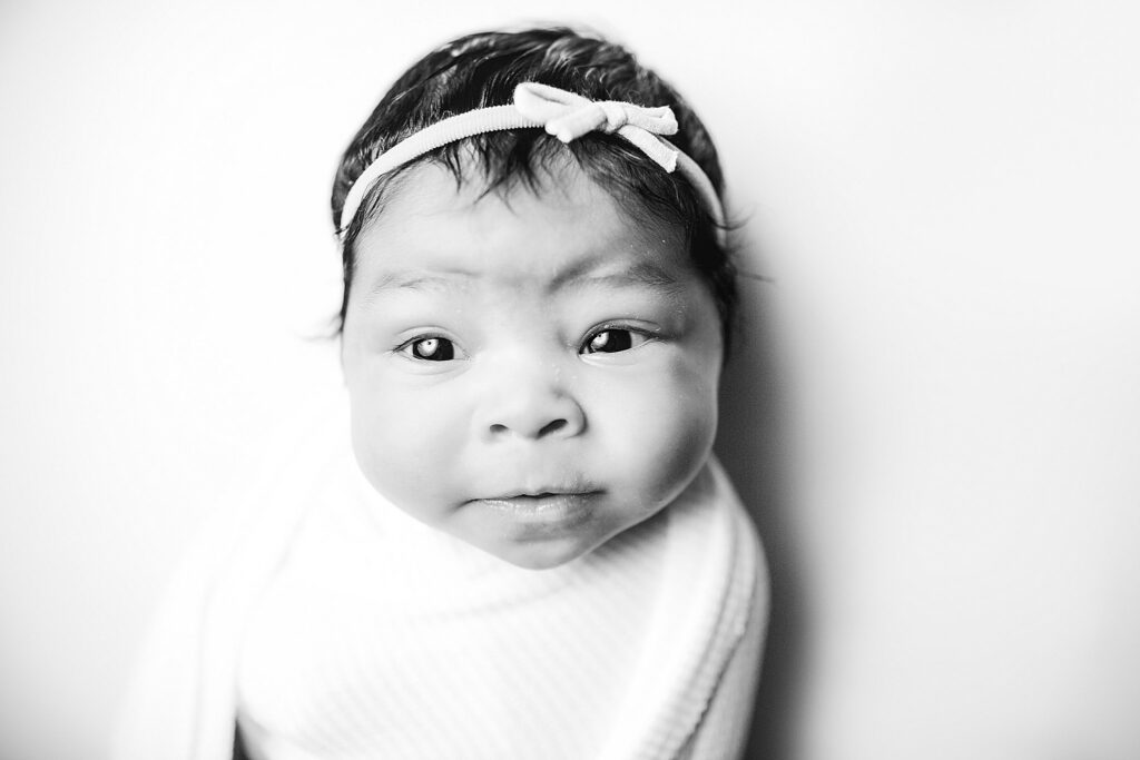 newborn black and white image of face and open eyes