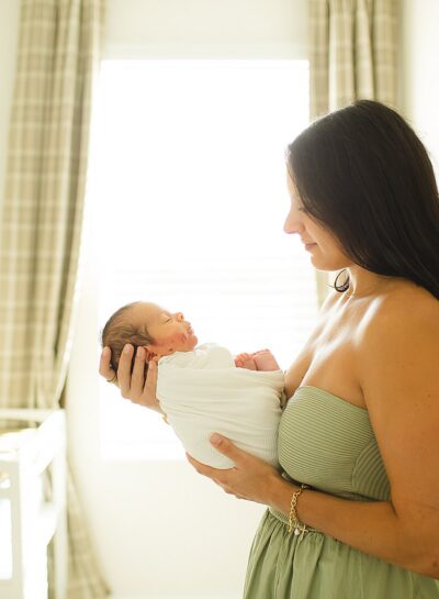 mom holding baby in pretty light